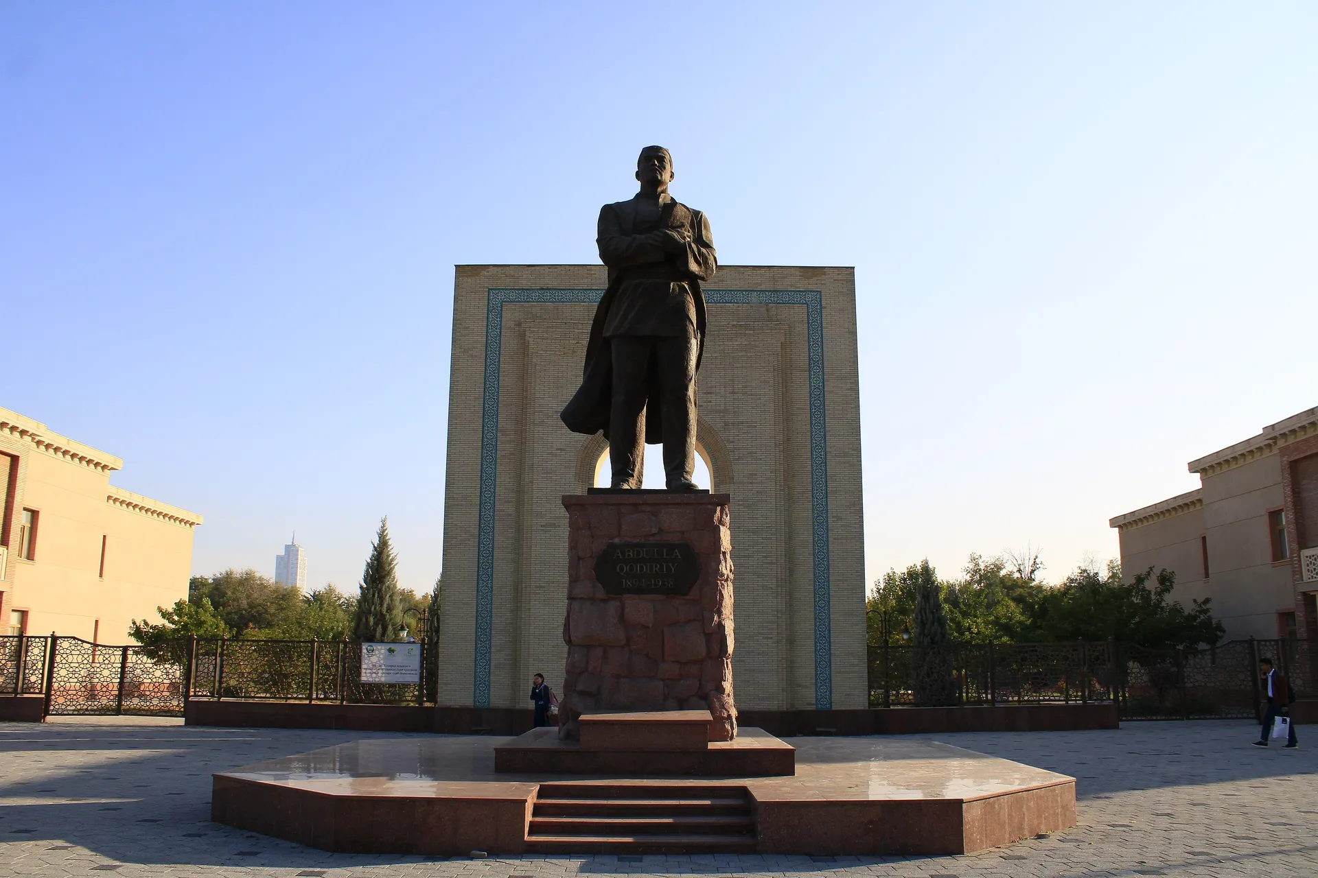 A statue of the writer in front of a tiled arch beside his house museum in Tashkent.