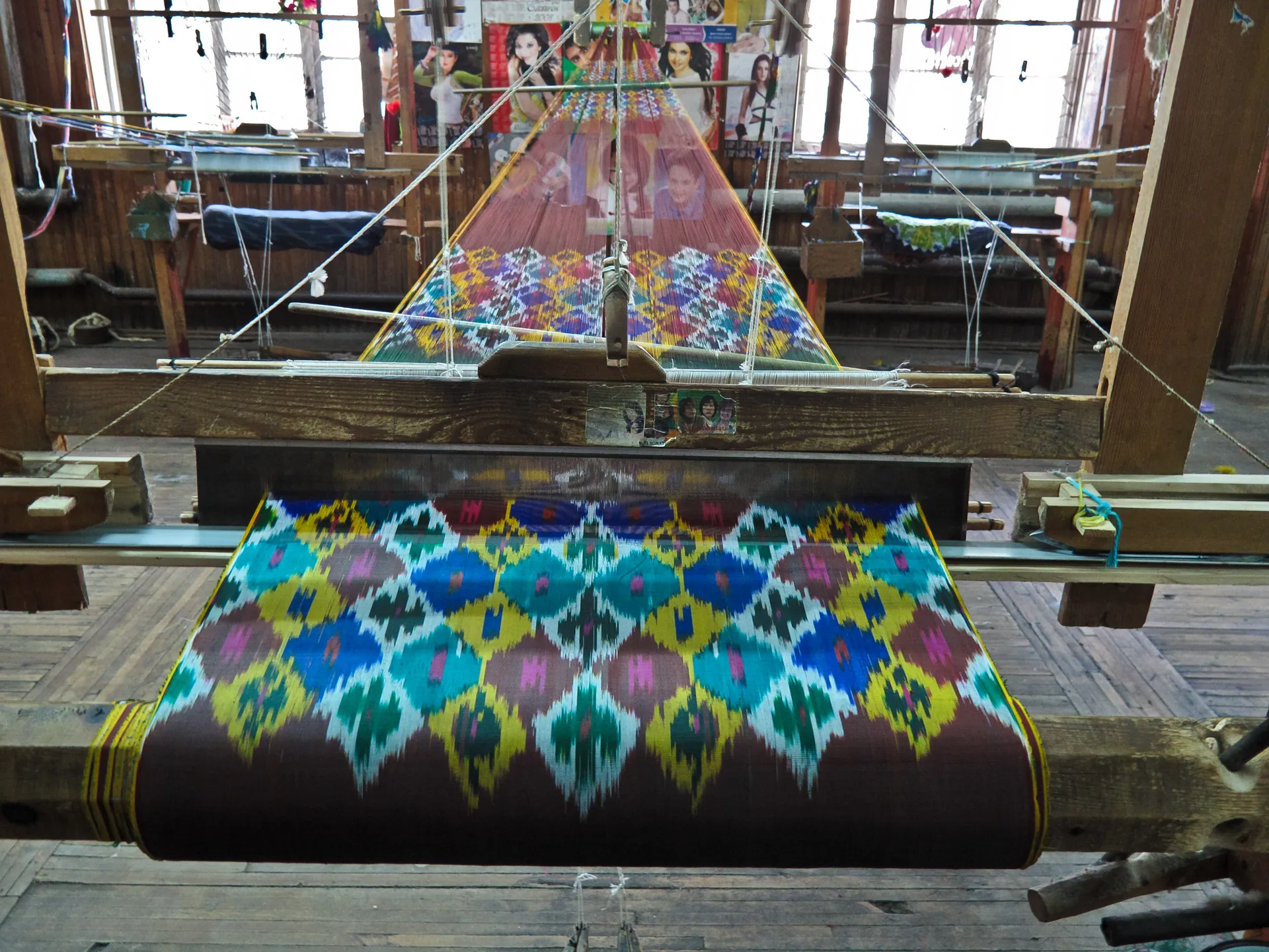 Ikat silk on a hand loom at the Yodgorlik silk factory in Margilan. The pattern is dyed into the threads before weaving, which gives its edges their soft blur.