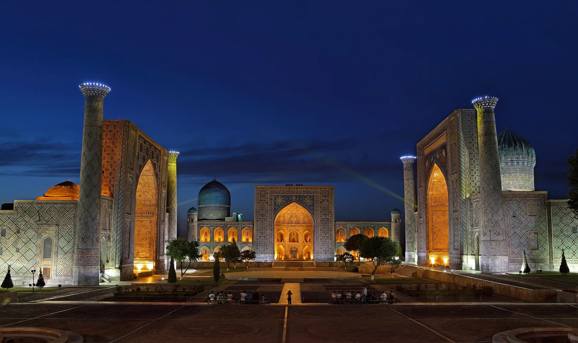 The three madrasahs of Registan Square in Samarkand, floodlit after dark.