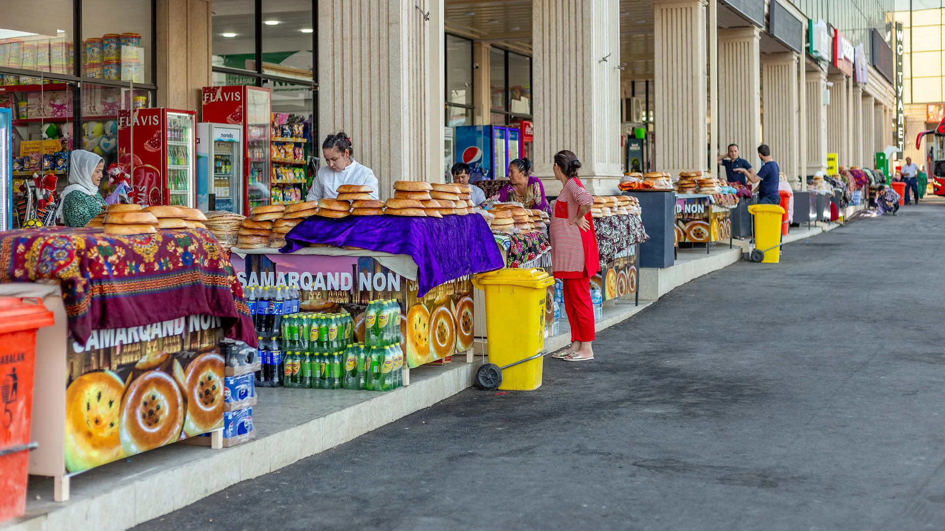 Stalls of Samarkand non at the city's bus station. The heavy, glossy loaves keep for days, so travellers take them home as gifts.