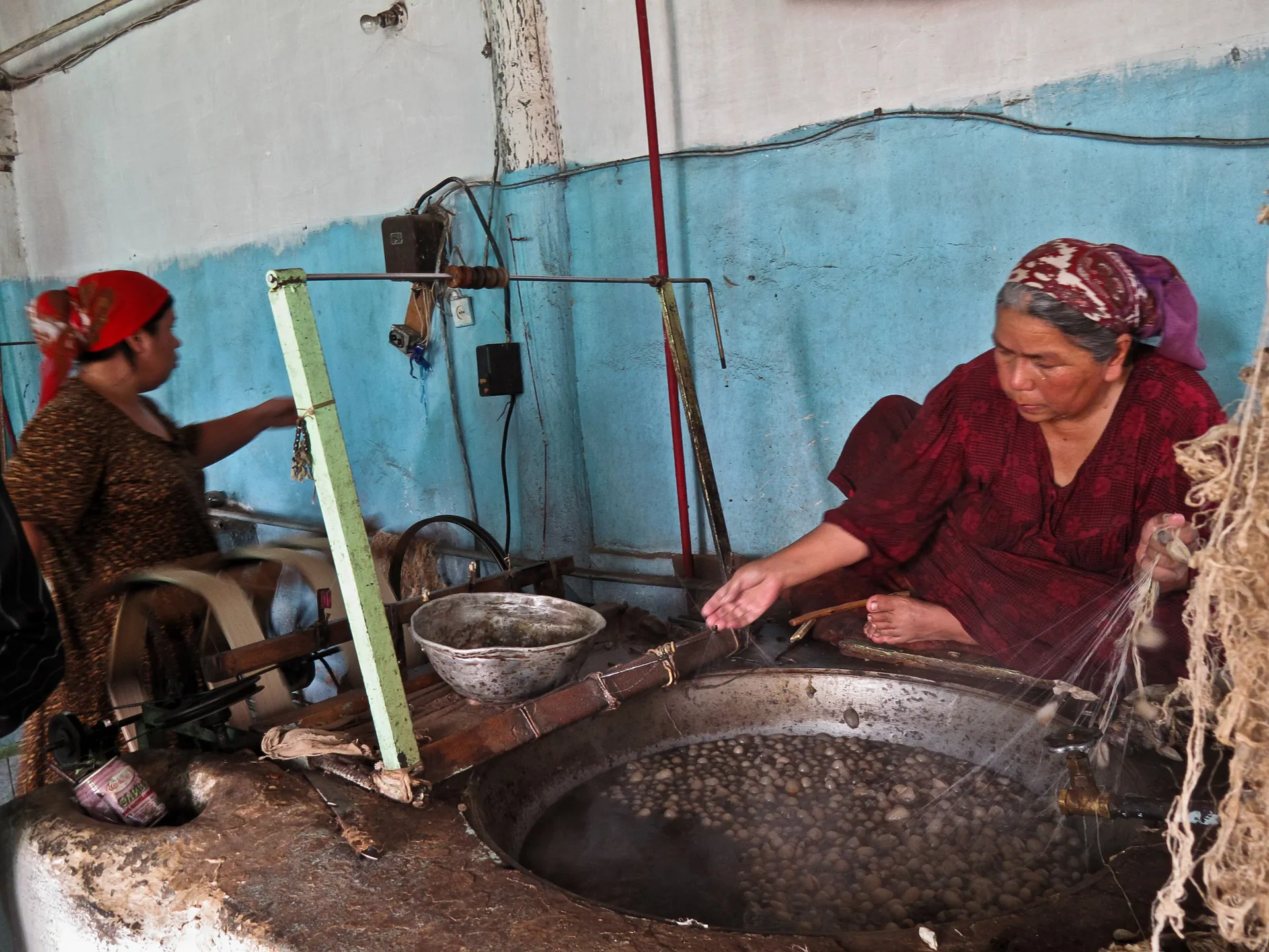 Cocoons softening in hot water while their filaments are reeled into thread at the Yodgorlik silk factory in Margilan.