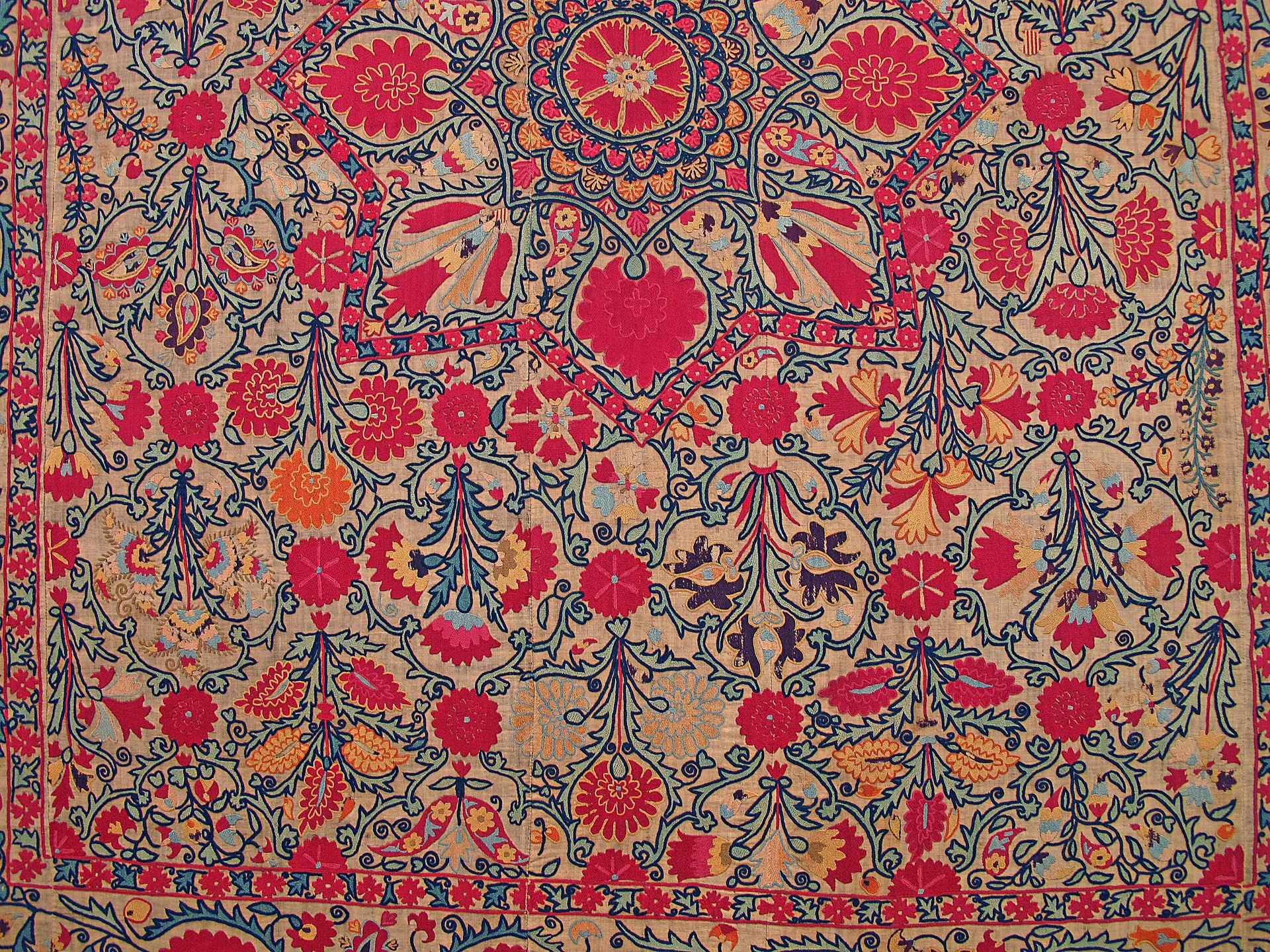 A silk-embroidered suzani in the Museum of Applied Arts in Tashkent: large floral rosettes worked onto cotton, traditionally sewn by a bride's family for her dowry.